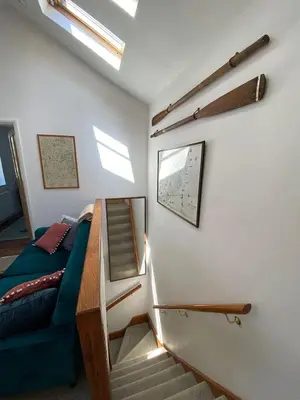 a room with a staircase and a bed and a stair case at Central, 10min walk to beach with off-road parking in Falmouth