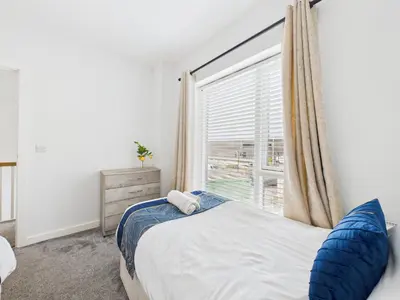 a bedroom with a bed and a large window at No4 Harveys Yard By Signature Stays - Luxury Stay - Beach - Parking in Hayle