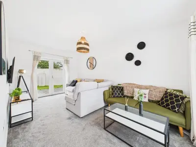 a living room with a couch and a table at No4 Harveys Yard By Signature Stays - Luxury Stay - Beach - Parking in Hayle