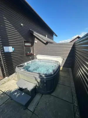 a hot tub in the backyard of a house at 5A Retallack Resort & Spa in Saint Columb Major