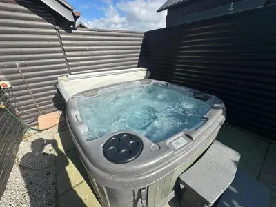 a hot tub in the backyard of a house at 5A Retallack Resort & Spa in Saint Columb Major