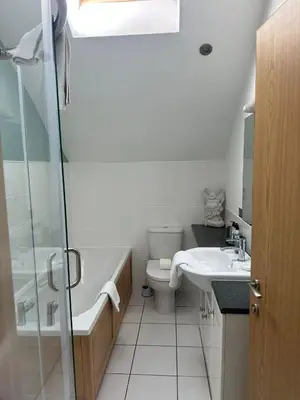 a bathroom with a toilet and a sink and a shower at 5A Retallack Resort & Spa in Saint Columb Major