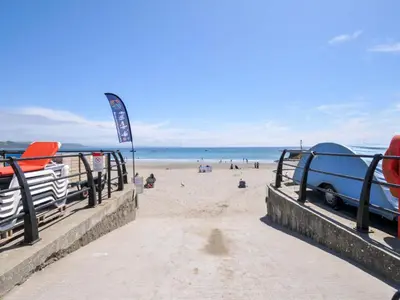 a beach with a car parked on the sand at Evelyn in Looe