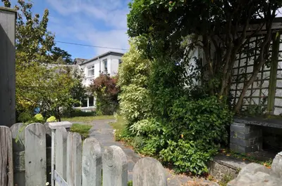 a wooden fence in front of a house at 2 Porthilly Cottages in Wadebridge