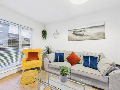 a living room with a couch and two chairs at Harveys Yard by Signature Stays - Luxury home - Beach - Parking in Hayle