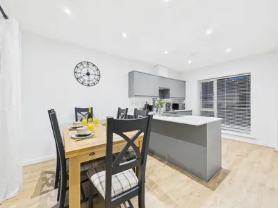 a kitchen and dining room with a table and chairs at Harveys Yard by Signature Stays - Luxury home - Beach - Parking in Hayle