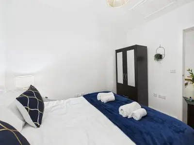 a bedroom with two towels on a bed at Harveys Yard by Signature Stays - Luxury home - Beach - Parking in Hayle
