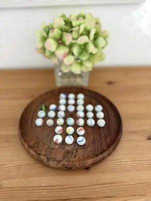 a vase filled with pills on top of a table at Meadow View - Widemouth Bay Cornwall in Widemouth Bay