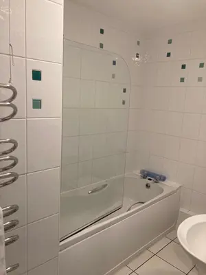 a white bathroom with a tub and a sink at 45 st Nicholas Court in St Ives