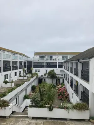 an apartment building with a courtyard with plants at 45 st Nicholas Court in St Ives