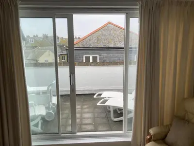 a view of a balcony with a sliding glass door at 45 st Nicholas Court in St Ives