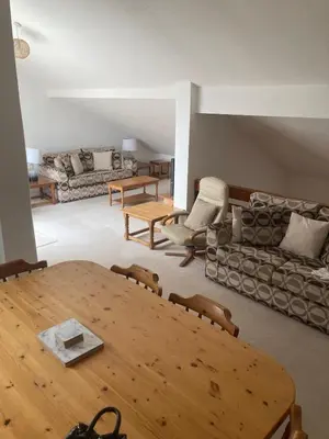a living room with a table and a couch at 45 st Nicholas Court in St Ives