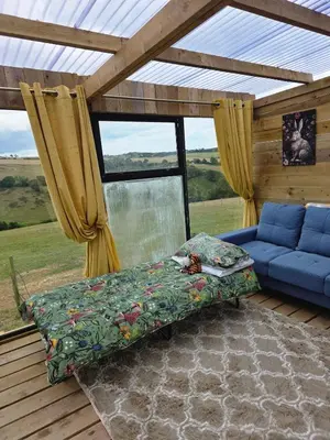 a living room with a couch and a window at Miss Francis Horse Wagon in Looe
