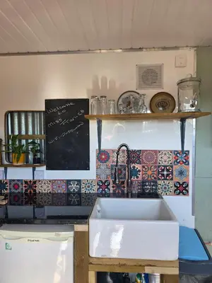 a kitchen with a sink and a counter with tiles at Miss Francis Horse Wagon in Looe