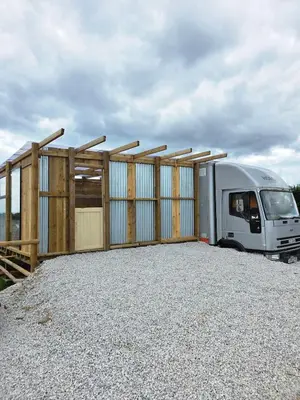 a trailer parked in front of a fence at Miss Francis Horse Wagon in Looe