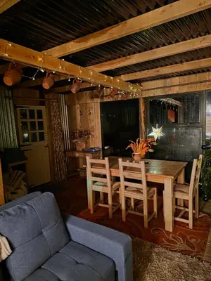 a living room with a wooden table and chairs at Miss Francis Horse Wagon in Looe