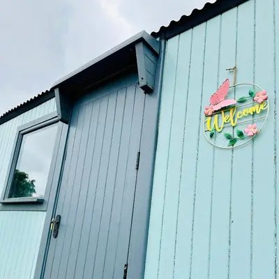 a sign on the side of a building at Harpers Huts in Lanivet