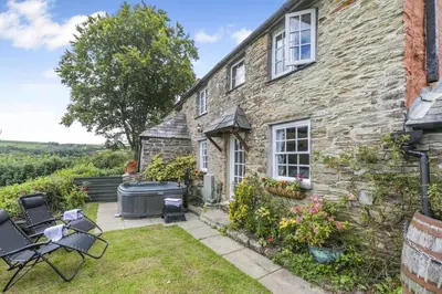 an exterior view of a stone house with a garden at 2 Bed in Liskeard oc-t32876 in Duloe