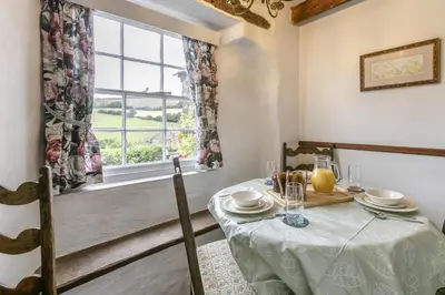 a dining room with a table and a window at 2 Bed in Liskeard oc-t32876 in Duloe