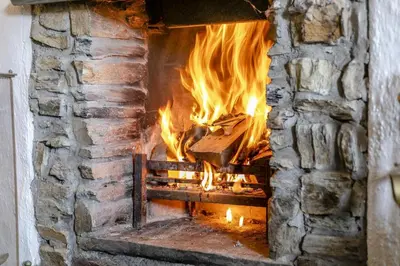 a brick oven with a fire in it at 2 Bed in Liskeard oc-t32876 in Duloe