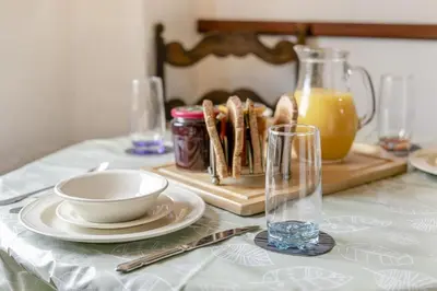 a table with a plate of food on a cutting board at 2 Bed in Liskeard oc-t32876 in Duloe
