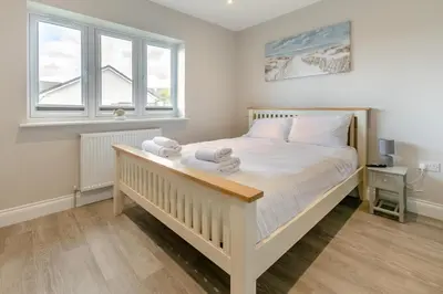 a bedroom with a large bed with towels on it at 4 Bed in Padstow oc-r32776 in Padstow