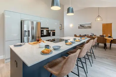 a kitchen and dining room with a long table and chairs at 4 Bed in Padstow oc-r32776 in Padstow