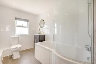 a white bathroom with a tub and a toilet at 3 Bed in Padstow oc-g32860 in Padstow