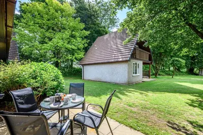 a patio with a table and chairs in a yard at 2 Bed in St. Tudy oc-m32233 in Saint Tudy