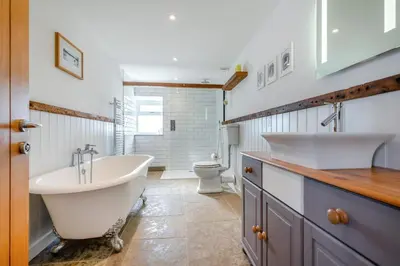 a bathroom with two sinks and a tub and a toilet at 3 Bed in St. Mawgan oc-h30677 in Saint Eval