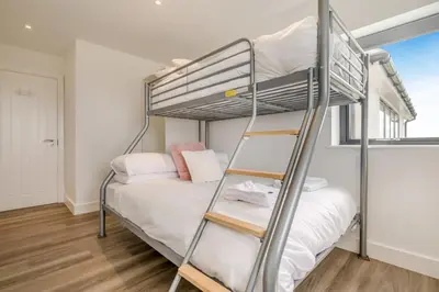 a bedroom with a bunk bed and a ladder at 3 Bed in Tintagel oc-e32938 in Tintagel