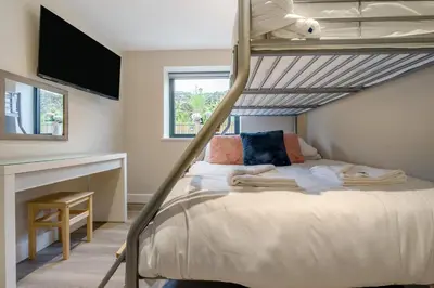 a bedroom with a bunk bed and a television at 2 Bed in Tintagel oc-a32939 in Tintagel