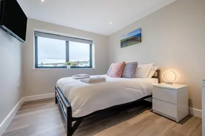 a bedroom with a large bed and a window at 2 Bed in Tintagel oc-a32939 in Tintagel