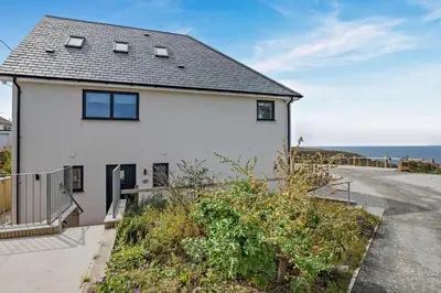 a white house with a view of the ocean at 2 Bed in Tintagel oc-a32939 in Tintagel