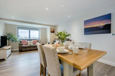a dining room and living room with a table and chairs at 2 Bed in Tintagel oc-a32939 in Tintagel