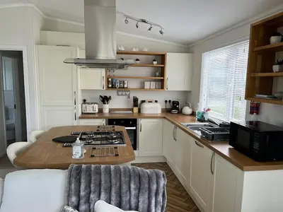 a kitchen with a table and a counter top at Lodge in St Merryn in St Merryn
