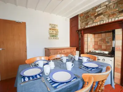 a table with blue and white plates on it in a kitchen at Tregundy Farmhouse in Perranporth