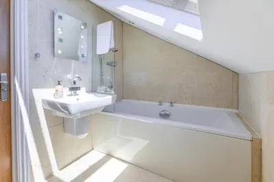 a bathroom with a white tub and a sink at 3 Bed in Newquay oc-o32259 in Newquay