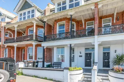 a large brick house with balconies on a street at 3 Bed in Newquay oc-o32259 in Newquay