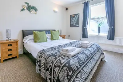 a bedroom with a bed and a window at 3 Bed in Newquay oc-o32259 in Newquay