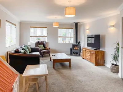 a living room with a couch and a fireplace at Kerensa in St. Agnes