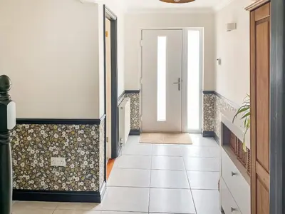 a hallway with a door and a tile floor at Kerensa in St. Agnes