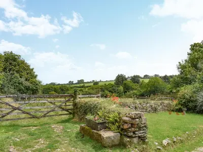 a gate in a field with a garden at Stables - Uk50372 in Camelford