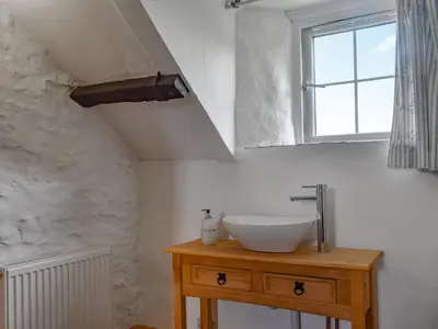 a bathroom with a sink and a window at Stables - Uk50372 in Camelford