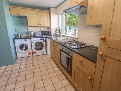 a kitchen with a washing machine and a washer at 28 Guildford Road in Hayle
