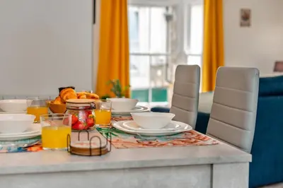 a table with plates of food and orange juice at 2 Bed in St. Ives oc-e28156 in St Ives