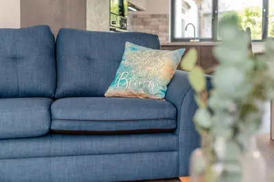 a blue couch with a pillow that says happy birthdayario at 2 Bed in St. Ives oc-e28156 in St Ives