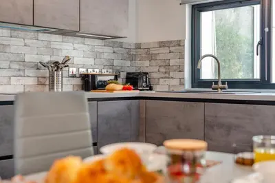 a kitchen with a sink and a table with bread at 2 Bed in St. Ives oc-e28156 in St Ives