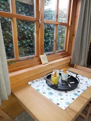 a tray with two cups on a table next to a window at The Nook in St Ives