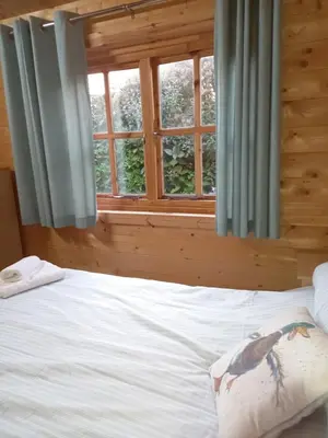a bedroom with a bed with a bird on the pillow at The Nook in St Ives